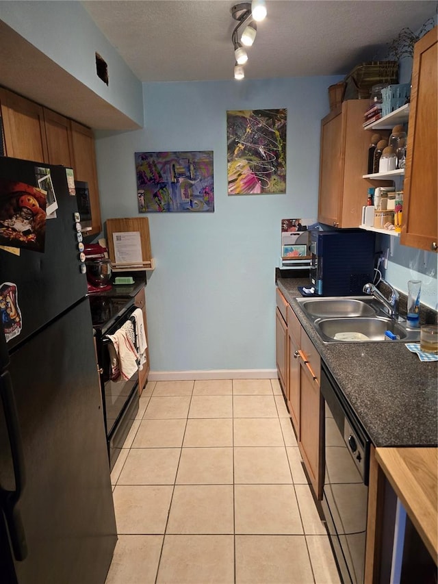 kitchen featuring light tile patterned floors, open shelves, a sink, brown cabinets, and black appliances