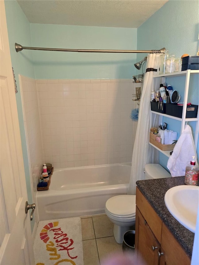 full bath featuring a textured ceiling, toilet, vanity, tile patterned floors, and shower / bath combo