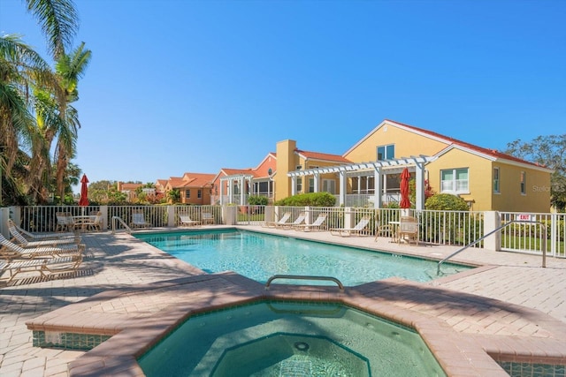 community pool featuring a pergola, fence, a hot tub, and a patio