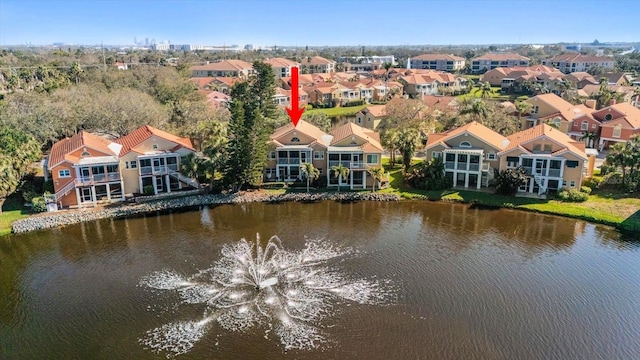 birds eye view of property with a water view and a residential view