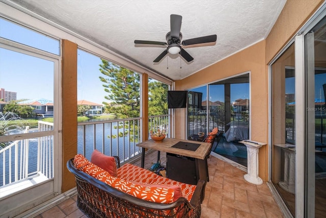 sunroom featuring ceiling fan