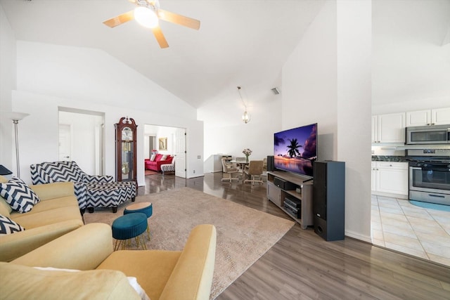 living area featuring visible vents, high vaulted ceiling, wood finished floors, and a ceiling fan