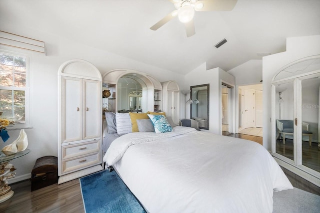 bedroom with lofted ceiling, visible vents, ceiling fan, and wood finished floors