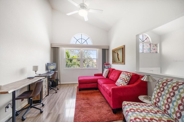 home office with lofted ceiling, ceiling fan, baseboards, and wood finished floors