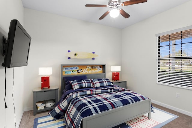 carpeted bedroom featuring ceiling fan and baseboards