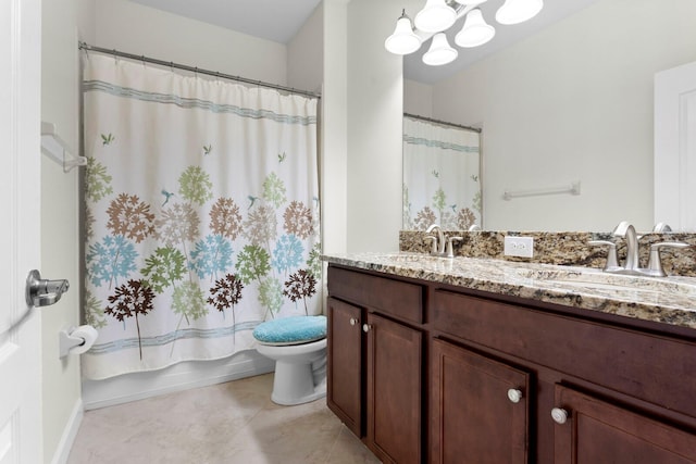 bathroom featuring double vanity, a sink, toilet, and tile patterned floors