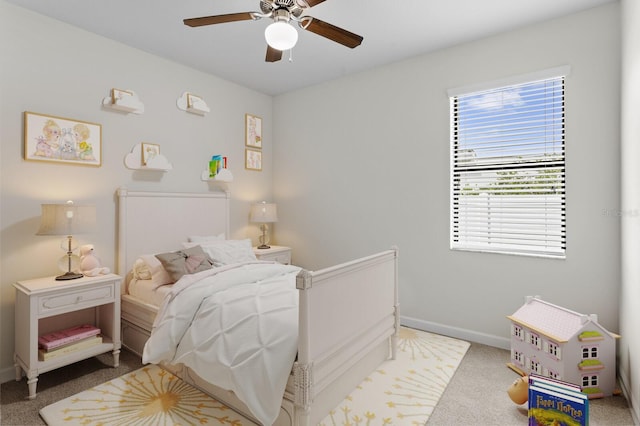 carpeted bedroom featuring baseboards and a ceiling fan