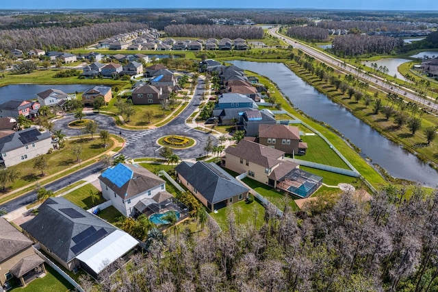 birds eye view of property featuring a water view and a residential view