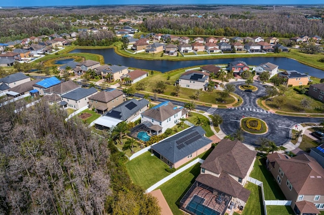 drone / aerial view with a residential view and a water view