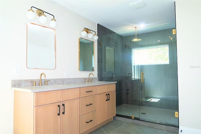 full bathroom with marble finish floor, double vanity, a stall shower, and a sink