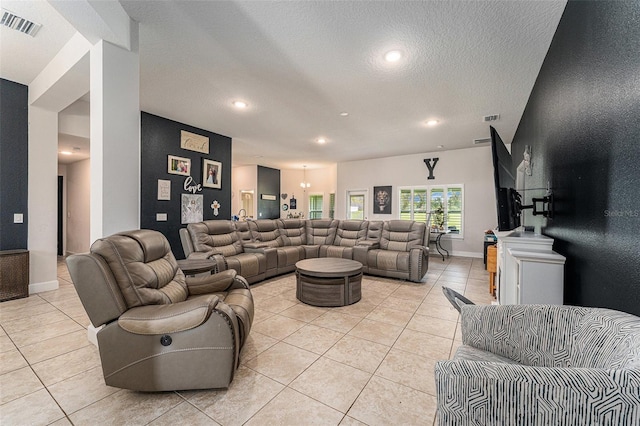 living area featuring recessed lighting, visible vents, a textured ceiling, and light tile patterned flooring