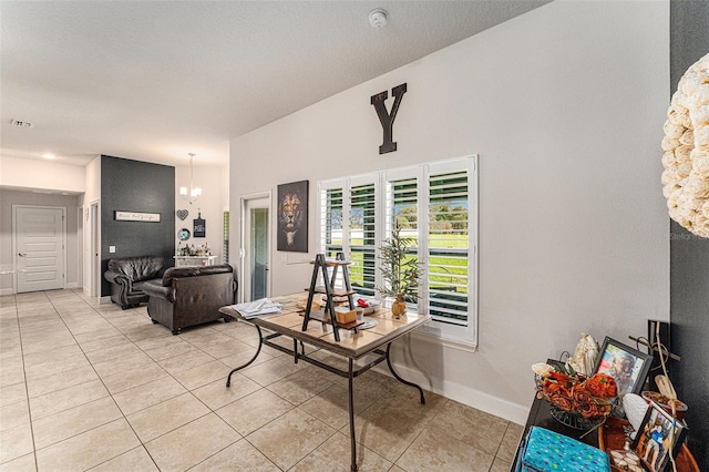 living area with visible vents, a notable chandelier, baseboards, and light tile patterned floors