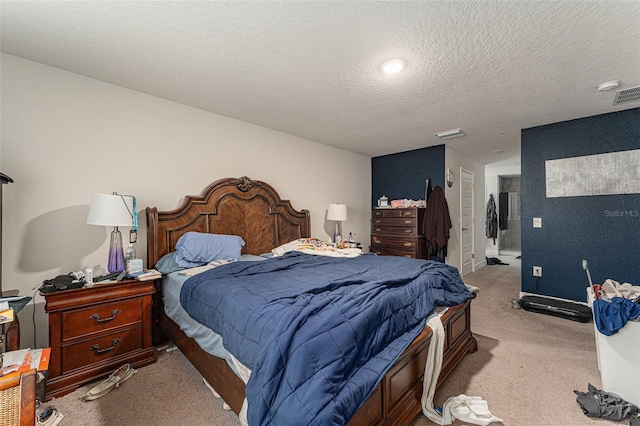 bedroom featuring visible vents, a textured ceiling, and carpet flooring