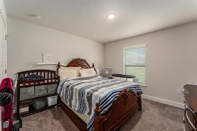 bedroom featuring a textured ceiling, carpet, and baseboards