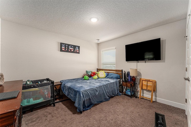 carpeted bedroom featuring baseboards and a textured ceiling