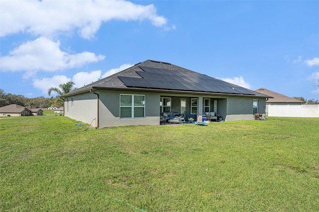 back of house with a patio area, fence, solar panels, and a yard