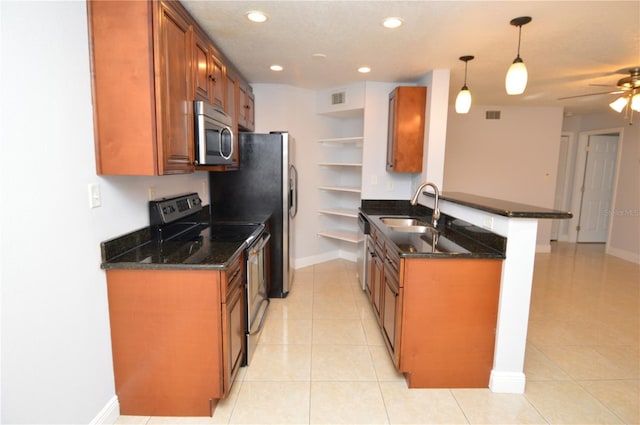 kitchen featuring open shelves, a peninsula, a sink, appliances with stainless steel finishes, and brown cabinets