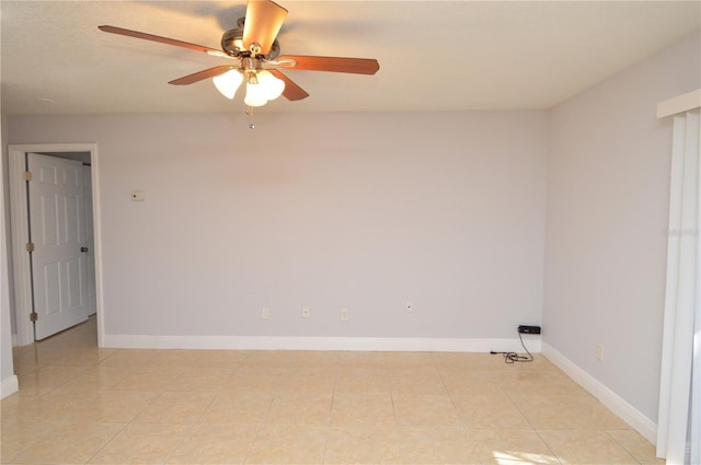unfurnished room featuring baseboards, ceiling fan, and light tile patterned flooring