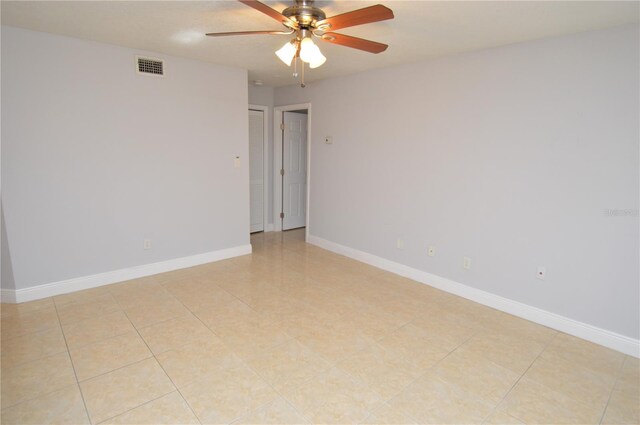 spare room with visible vents, baseboards, and ceiling fan
