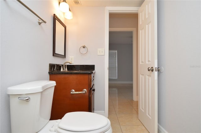 half bath with tile patterned floors, visible vents, toilet, baseboards, and vanity