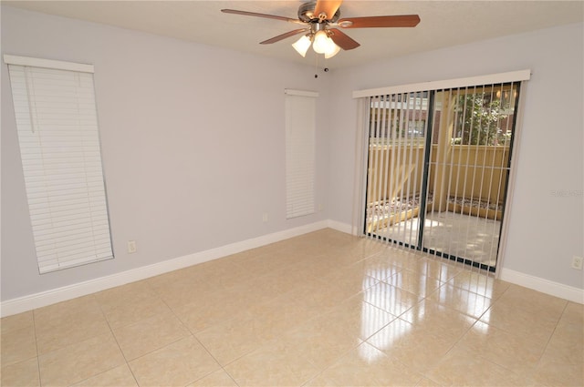spare room featuring tile patterned flooring, baseboards, and ceiling fan
