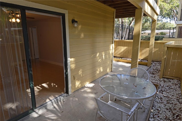 view of patio with outdoor dining area and fence