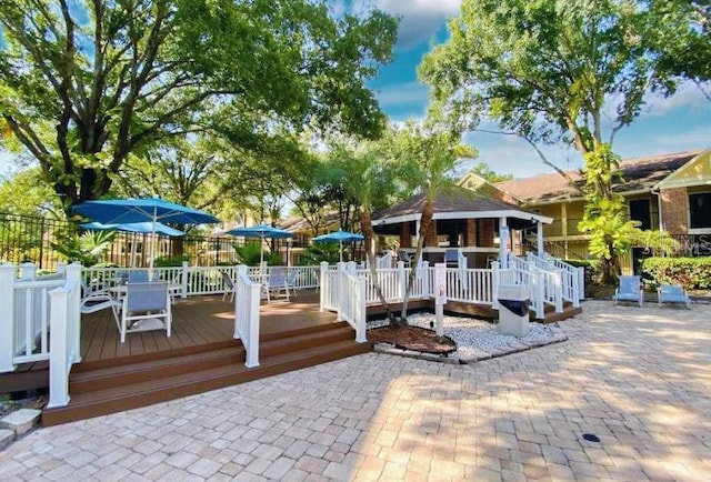 view of dock with a deck and fence