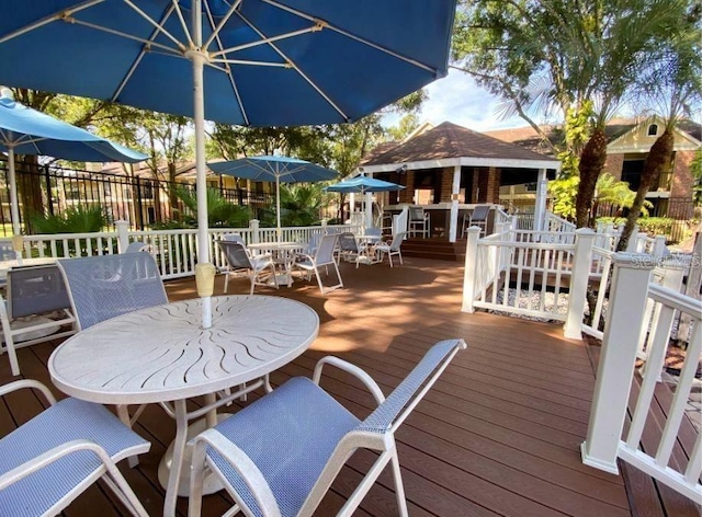 deck featuring outdoor dining space and an outdoor structure