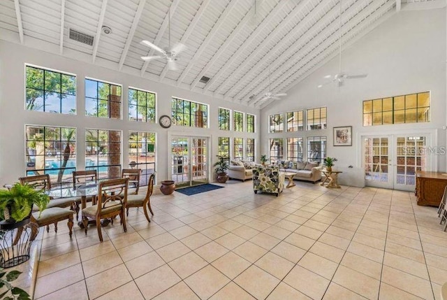 sunroom featuring french doors, lofted ceiling, visible vents, and ceiling fan