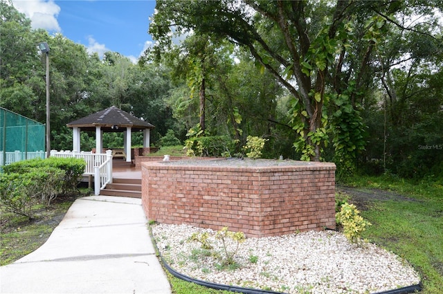 view of property's community with a gazebo and fence