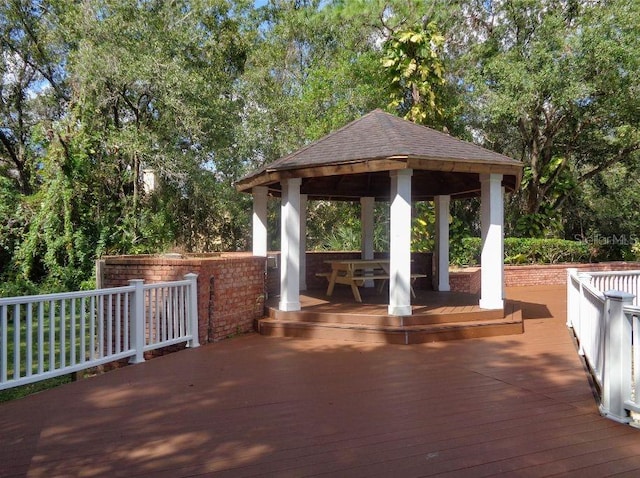 surrounding community featuring a gazebo and a wooden deck