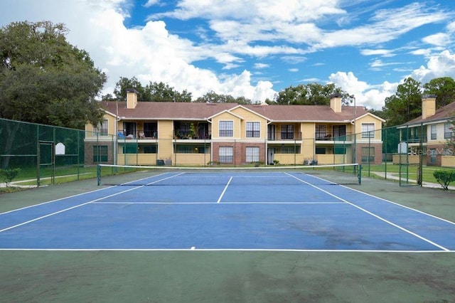 view of tennis court featuring fence