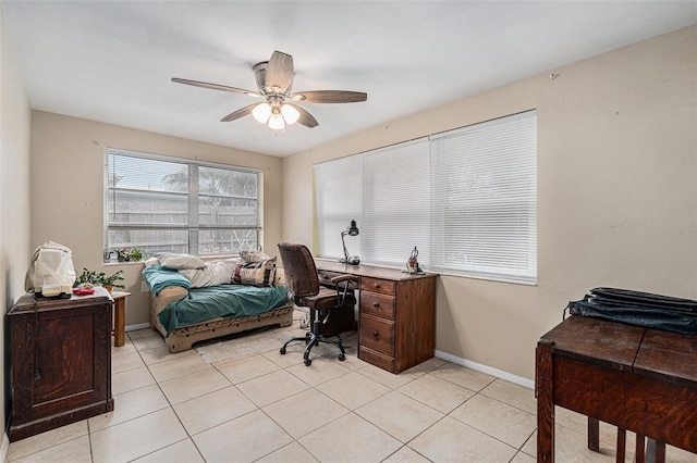 bedroom featuring baseboards, a ceiling fan, and light tile patterned flooring