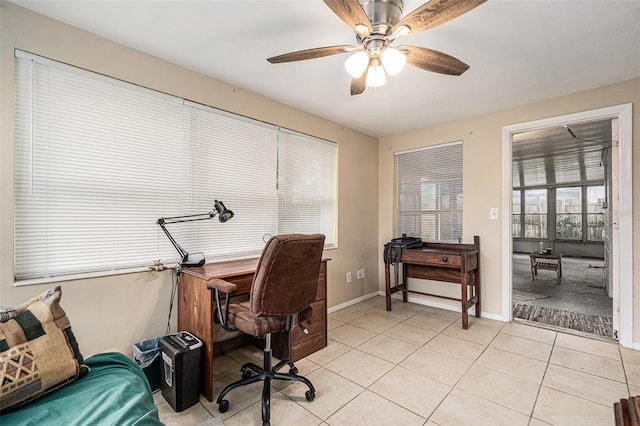 office area with light tile patterned floors, baseboards, and a ceiling fan