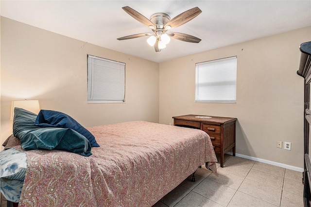 bedroom with a ceiling fan, baseboards, and light tile patterned floors