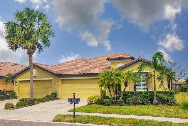 mediterranean / spanish-style house featuring a garage, a tile roof, driveway, and stucco siding