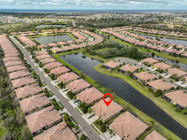 bird's eye view with a residential view and a water view