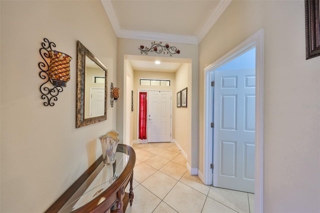 doorway to outside with baseboards, light tile patterned flooring, and crown molding