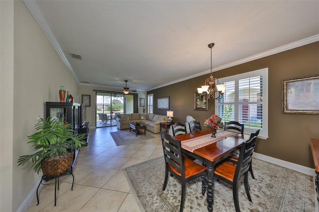 dining space with light tile patterned floors, visible vents, ornamental molding, baseboards, and ceiling fan with notable chandelier