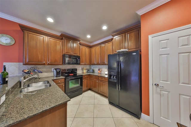 kitchen featuring ornamental molding, stone countertops, a sink, and black appliances