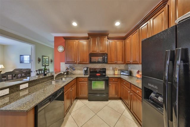 kitchen featuring decorative backsplash, a peninsula, black appliances, a sink, and light tile patterned flooring