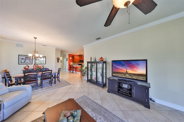 living area with light tile patterned floors, baseboards, visible vents, and ornamental molding