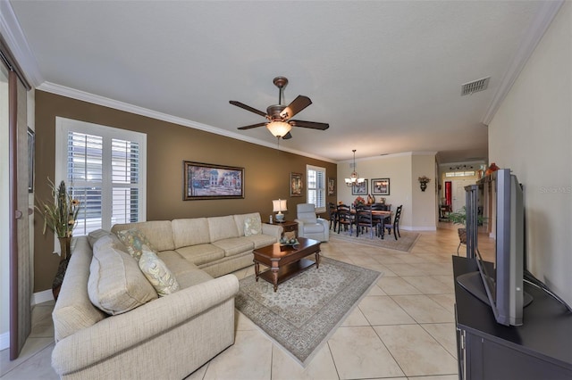 living room featuring ornamental molding, light tile patterned flooring, visible vents, and a healthy amount of sunlight