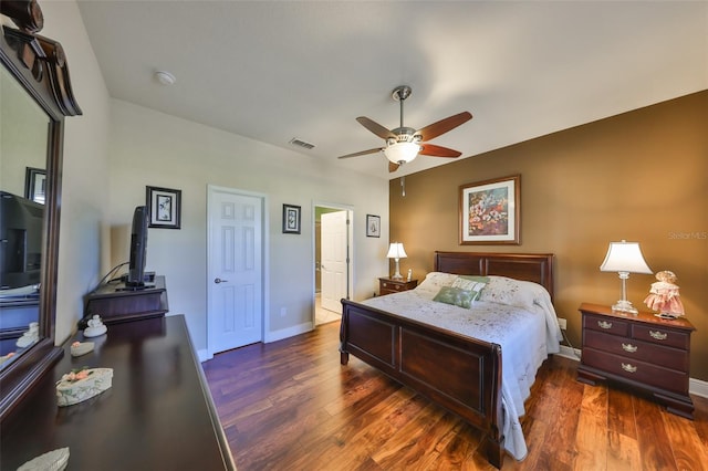 bedroom featuring baseboards, visible vents, ceiling fan, and wood finished floors