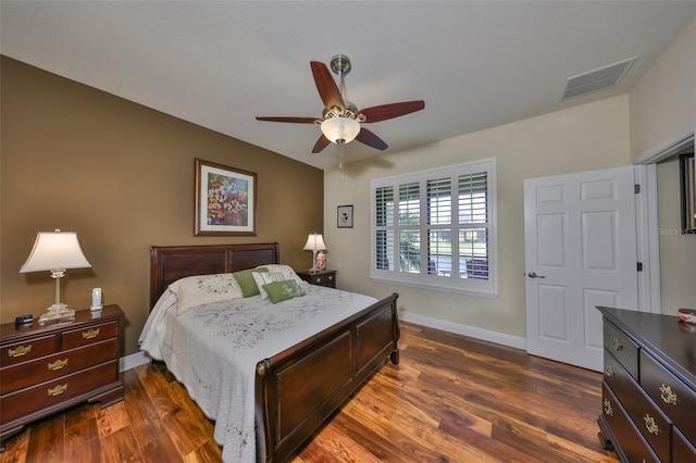 bedroom featuring ceiling fan, baseboards, visible vents, and dark wood finished floors