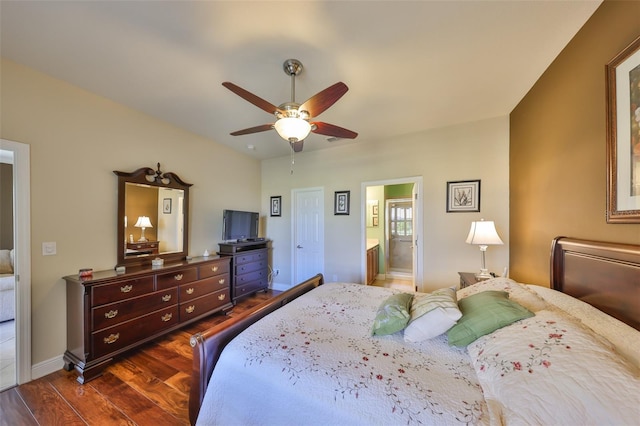 bedroom featuring a ceiling fan, dark wood-style flooring, connected bathroom, and baseboards