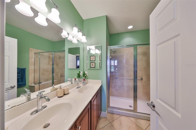 bathroom with a shower stall and a sink