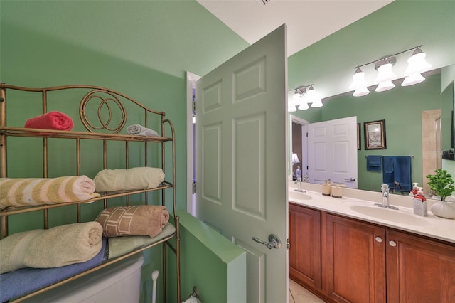 bathroom featuring a sink and double vanity