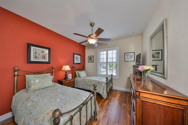 bedroom featuring a ceiling fan, baseboards, and dark wood-style flooring