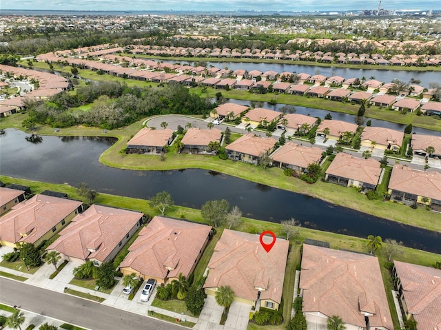 drone / aerial view featuring a water view and a residential view